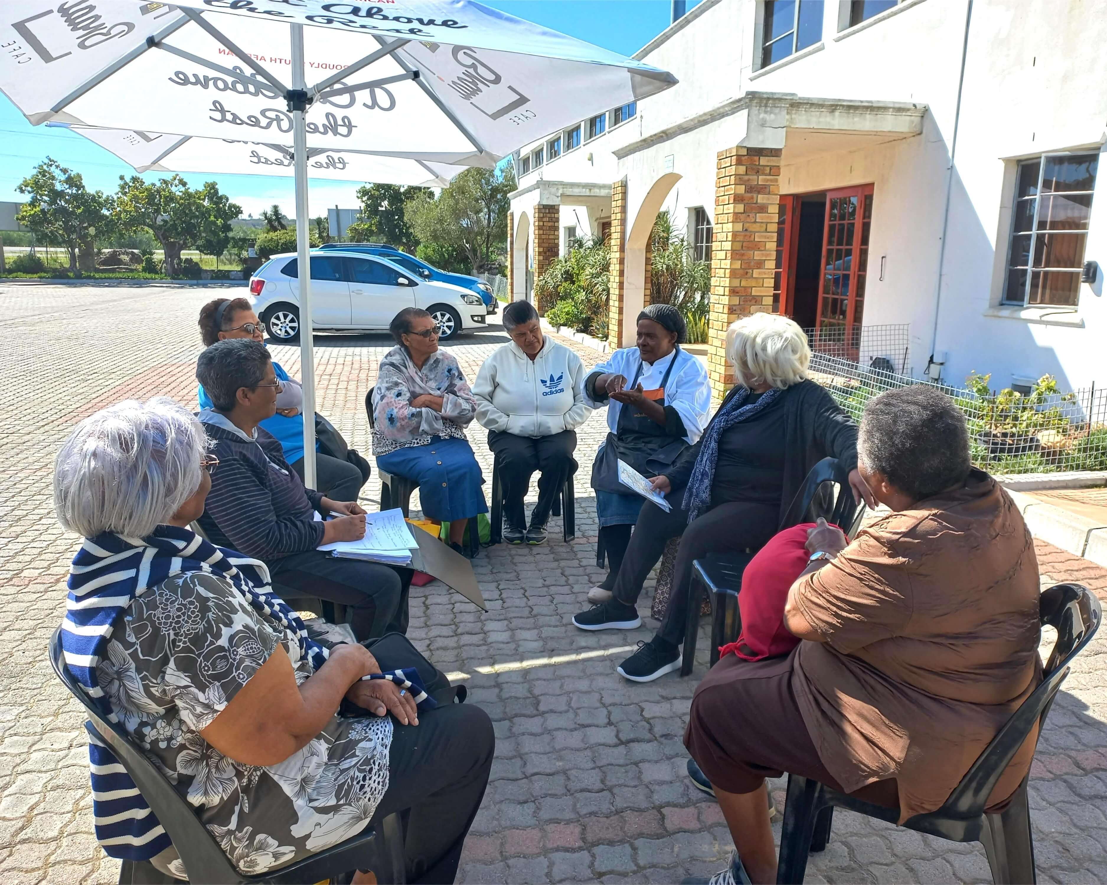 People of various ages sitting in a circle